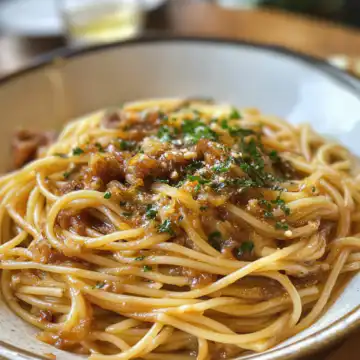 Caramelized Onion Pasta With Chilli Oil taken with iphone 15 pro max --iw 2 --ar 4:5 --v 6.1 --raw