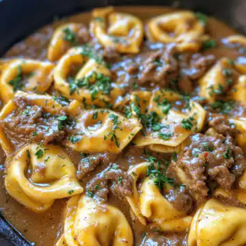 Cheesesteak Tortellini In Rich Provolone Sauce taken with iphone 15 pro max --iw 2 --ar 4:5 --v 6.1 --raw