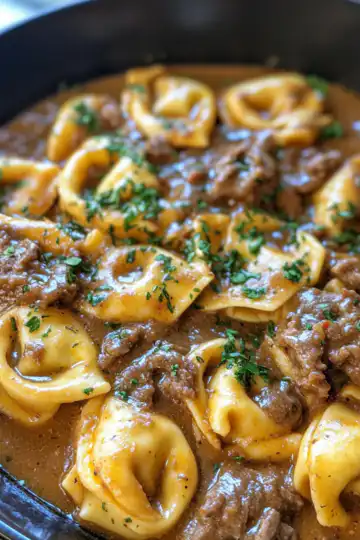 Cheesesteak Tortellini In Rich Provolone Sauce taken with iphone 15 pro max --iw 2 --ar 4:5 --v 6.1 --raw