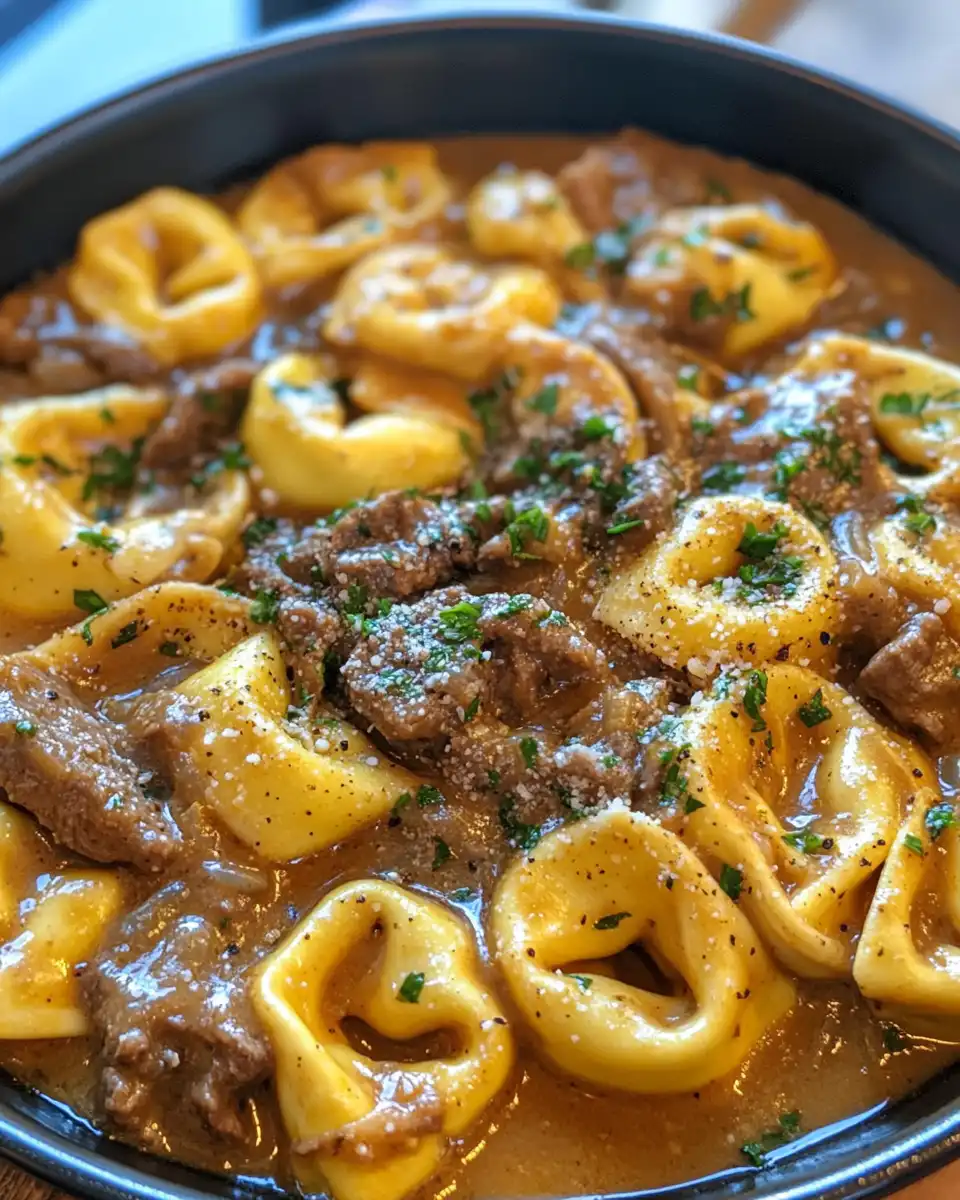Plated finished cheesesteak tortellini with sprinkle of fresh parsley