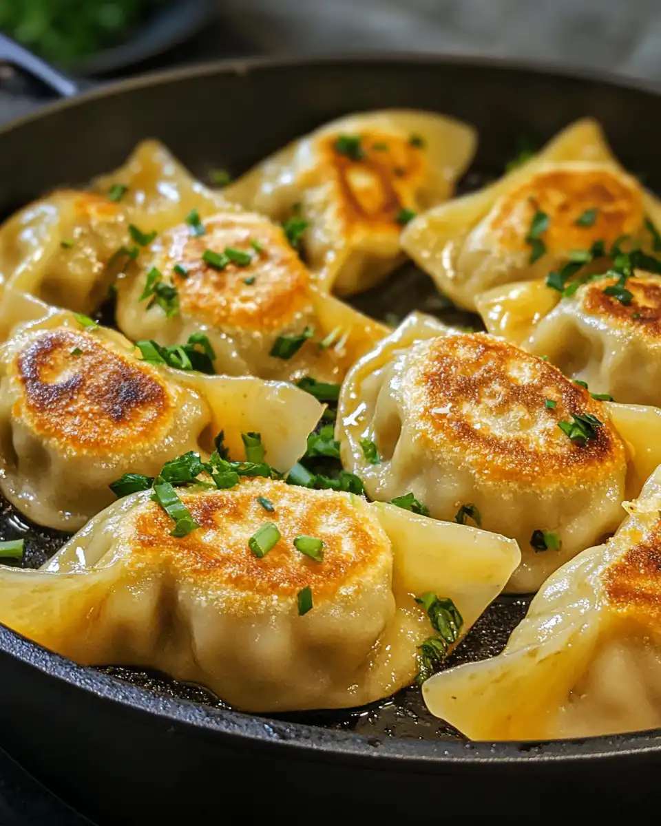 Close up of finished coconut curry dumplings with spinach and sauce