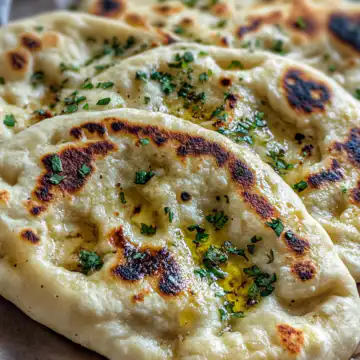 Easy Garlic Naan taken with iphone 15 pro max --iw 2 --ar 4:5 --v 6.1 --raw
