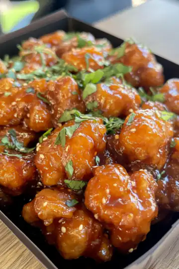 Gluten Free Orange Chicken taken with iphone 15 pro max --iw 2 --ar 4:5 --v 6.1 --raw