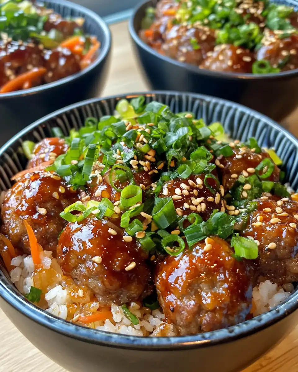 Served Korean BBQ meatball rice bowl garnished with green onions and sesame seeds
