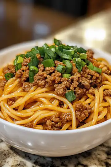 Mongolian Ground Beef Noodles taken with iphone 15 pro max --iw 2 --ar 4:5 --v 6.1 --raw