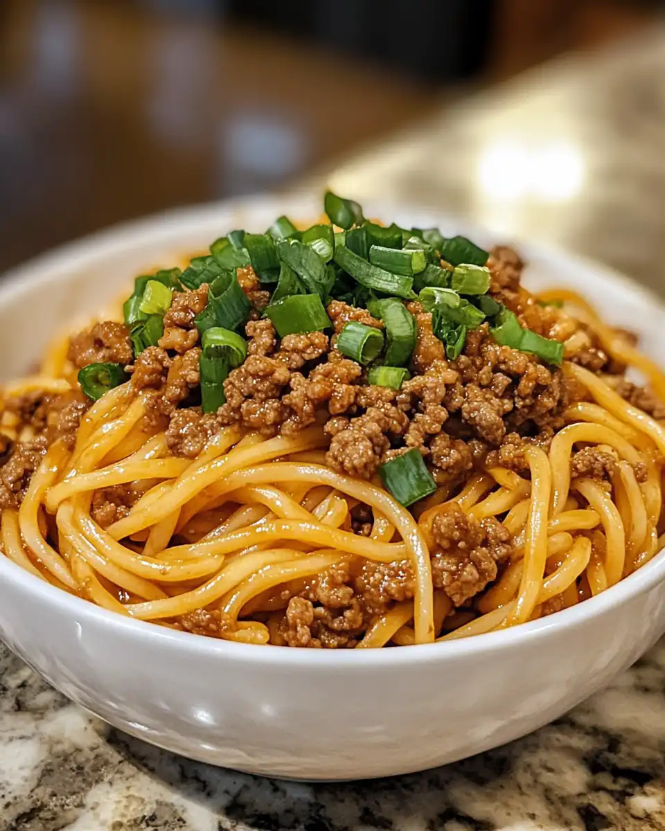 Close-up of Mongolian ground beef noodles cooking in pressure cooker