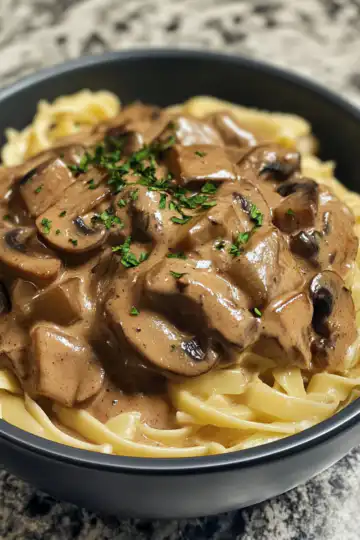 Mushroom And Seitan Stroganoff taken with iphone 15 pro max --iw 2 --ar 4:5 --v 6.1 --raw