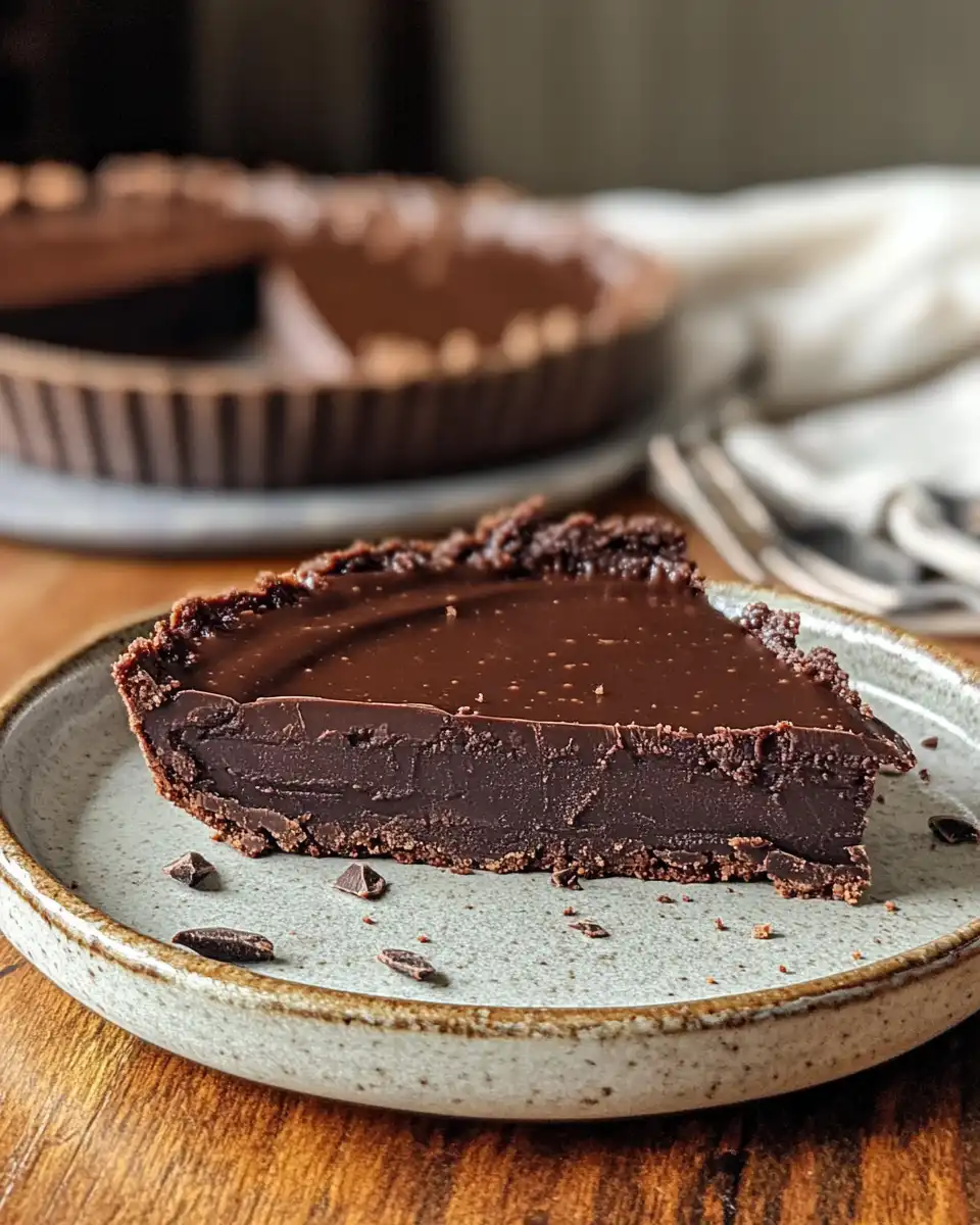 Vegan chocolate torte slice topped with cherry compote