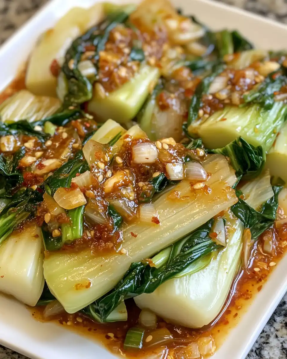 Pressure cooker with fresh ingredients including baby bok choy and garlic simmering
