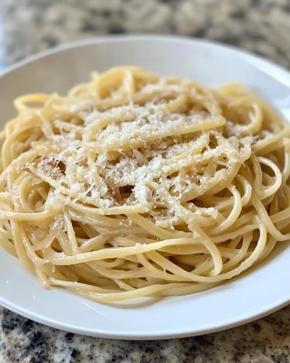 Sliced onions caramelizing with olive oil and pasta water in skillet