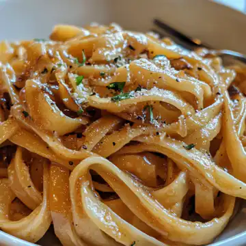 Vegan Caramelized Onion Pasta taken with iphone 15 pro max --iw 2 --ar 4:5 --v 6.1 --raw
