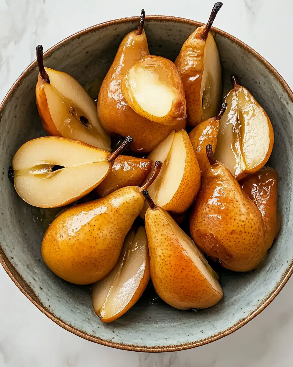 Finished baked pears topped with honey butter and walnuts