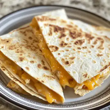 Cheese quesadillas taken with iphone 15 pro max --iw 2 --ar 4:5 --v 6.1 --raw