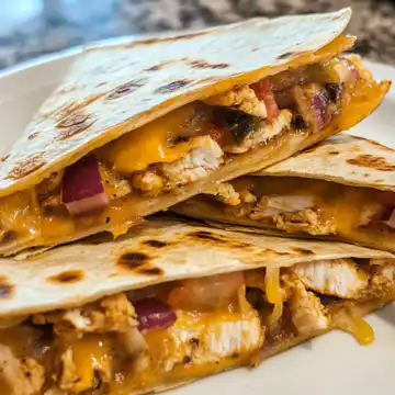 Chicken quesadillas taken with iphone 15 pro max --iw 2 --ar 4:5 --v 6.1 --raw