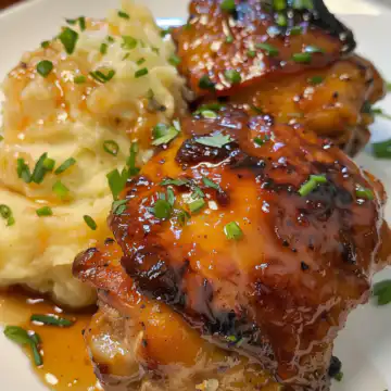 Chipotle Honey Chicken Thighs with Smoked Gouda Mashed Potatoes taken with iphone 15 pro max --iw 2 --ar 4:5 --v 6.0 --raw
