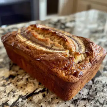 Cinnamon Swirl Banana Bread taken with iphone 15 pro max --iw 2 --ar 4:5 --v 6.0 --raw