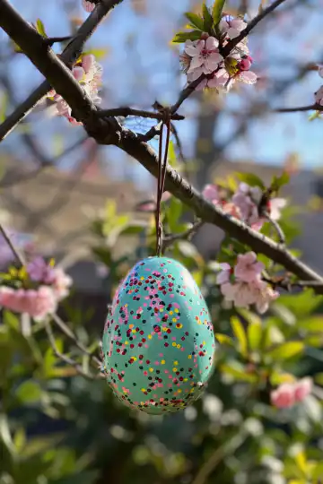 Easter Egg Bird Feeder taken with iphone 15 pro max --iw 2 --ar 4:5 --v 6.0 --raw