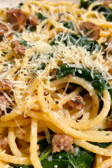 Garlic Butter Spaghetti with Cheesy Italian Sausage and Spinach taken with iphone 15 pro max --iw 2 --ar 4:5 --v 6.0 --raw