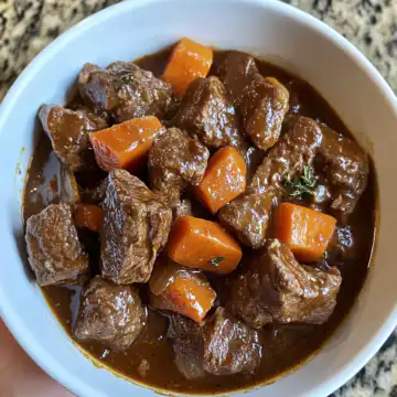 Guinness beef stew taken with iphone 15 pro max --iw 2 --ar 4:5 --v 6.1 --raw