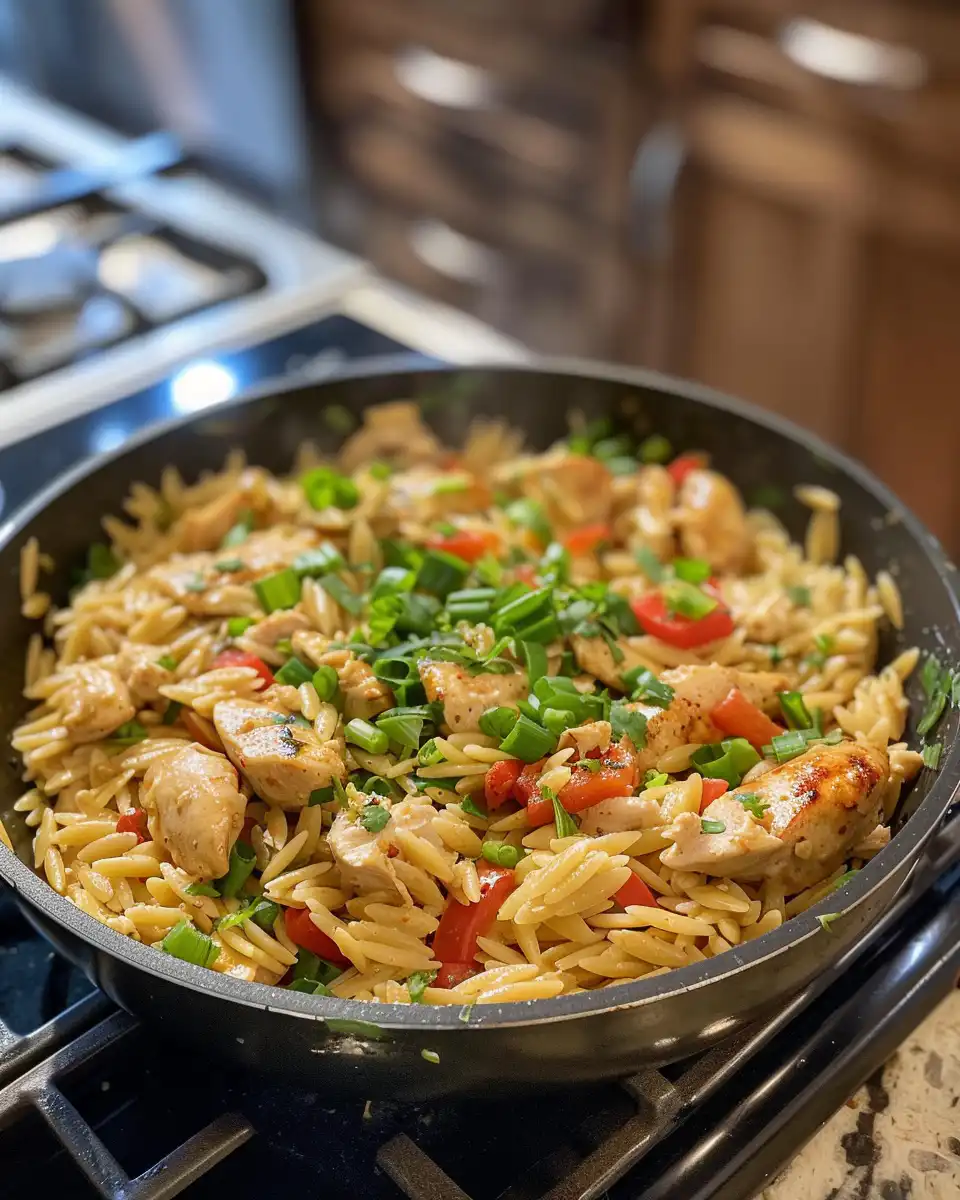 Cooking cubed tofu golden brown in skillet for Cajun chicken alfredo orzo