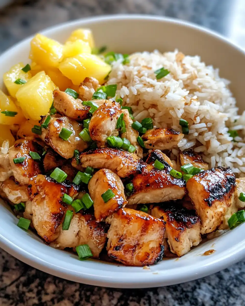 Fresh pineapple chicken with coconut rice in bowl, ready to eat