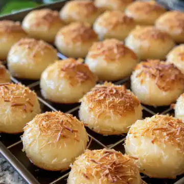 Portuguese Coconut Cakes taken with iphone 15 pro max --iw 2 --ar 4:5 --v 6.0 --raw