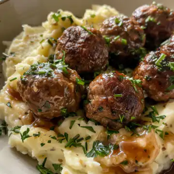 Salisbury Steak Meatballs with Garlic Herb Mashed Potatoes taken with iphone 15 pro max --iw 2 --ar 4:5 --v 6.0 --raw