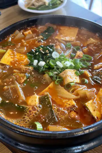 Budae Jjigae Korean Army Stew taken with iphone 15 pro max --iw 2 --ar 4:5 --v 6.0 --raw