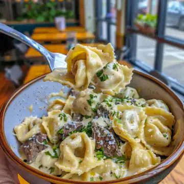Cheesesteak Tortellini in Creamy Provolone Sauce taken with iphone 15 pro max --iw 2 --ar 4:5 --v 6.0 --raw