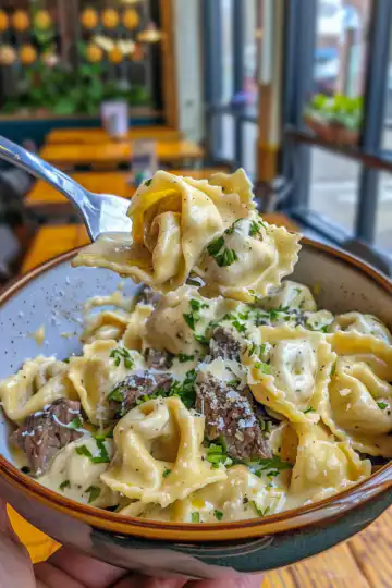 Cheesesteak Tortellini in Creamy Provolone Sauce taken with iphone 15 pro max --iw 2 --ar 4:5 --v 6.0 --raw