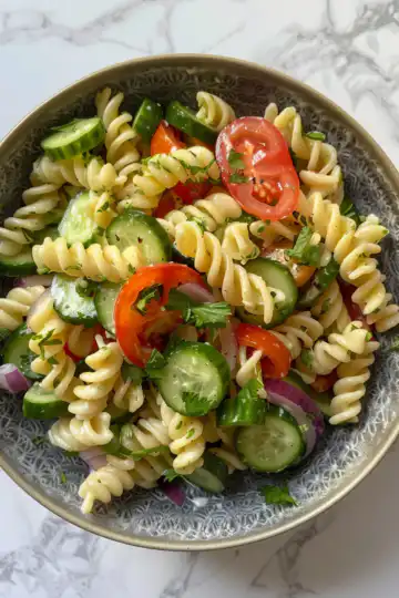 Cucumber Pasta Salad taken with iphone 15 pro max --iw 2 --ar 4:5 --v 6.0 --raw