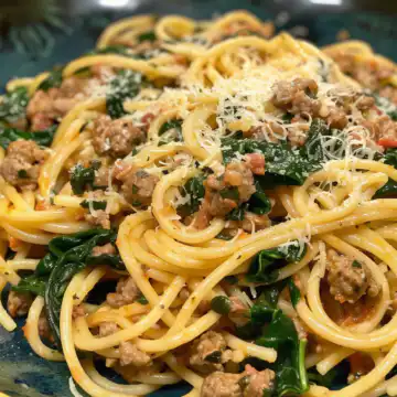 Garlic Butter Spaghetti with Cheesy Italian Sausage and Spinach taken with iphone 15 pro max --iw 2 --ar 4:5 --v 6.0 --raw