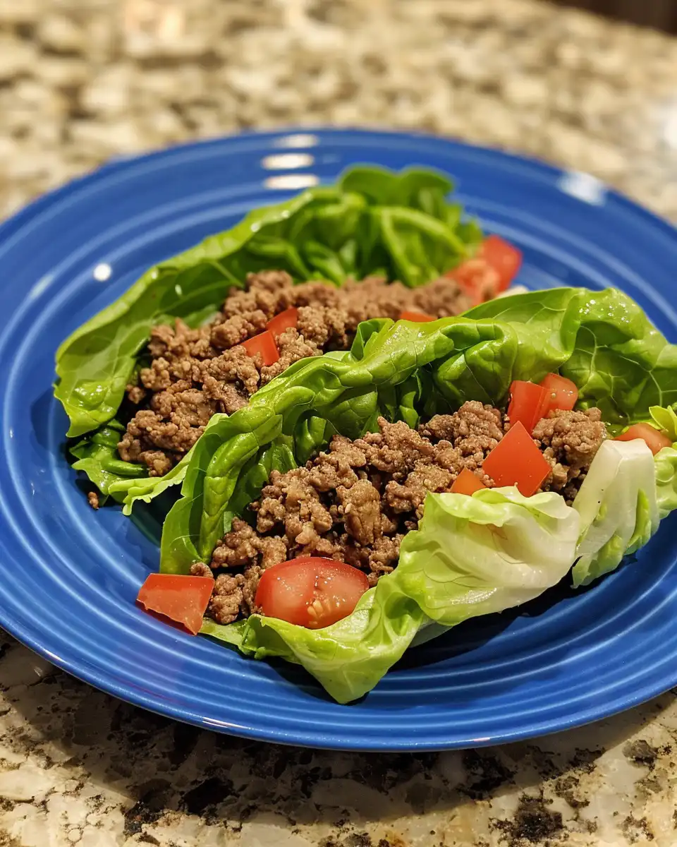 Ingredients prepared for ground beef lettuce wraps including peppers and onions