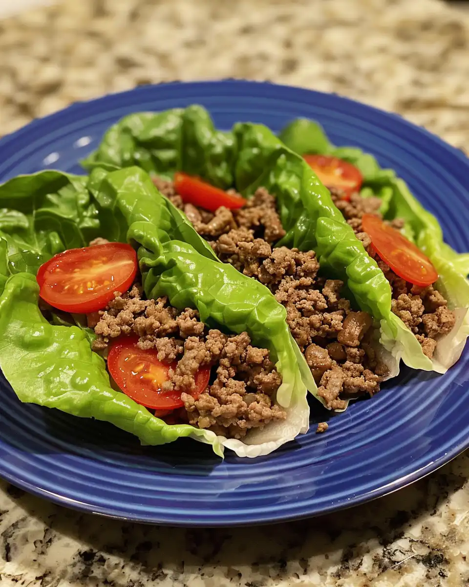 Served ground beef lettuce wraps with sesame seeds and fresh herbs