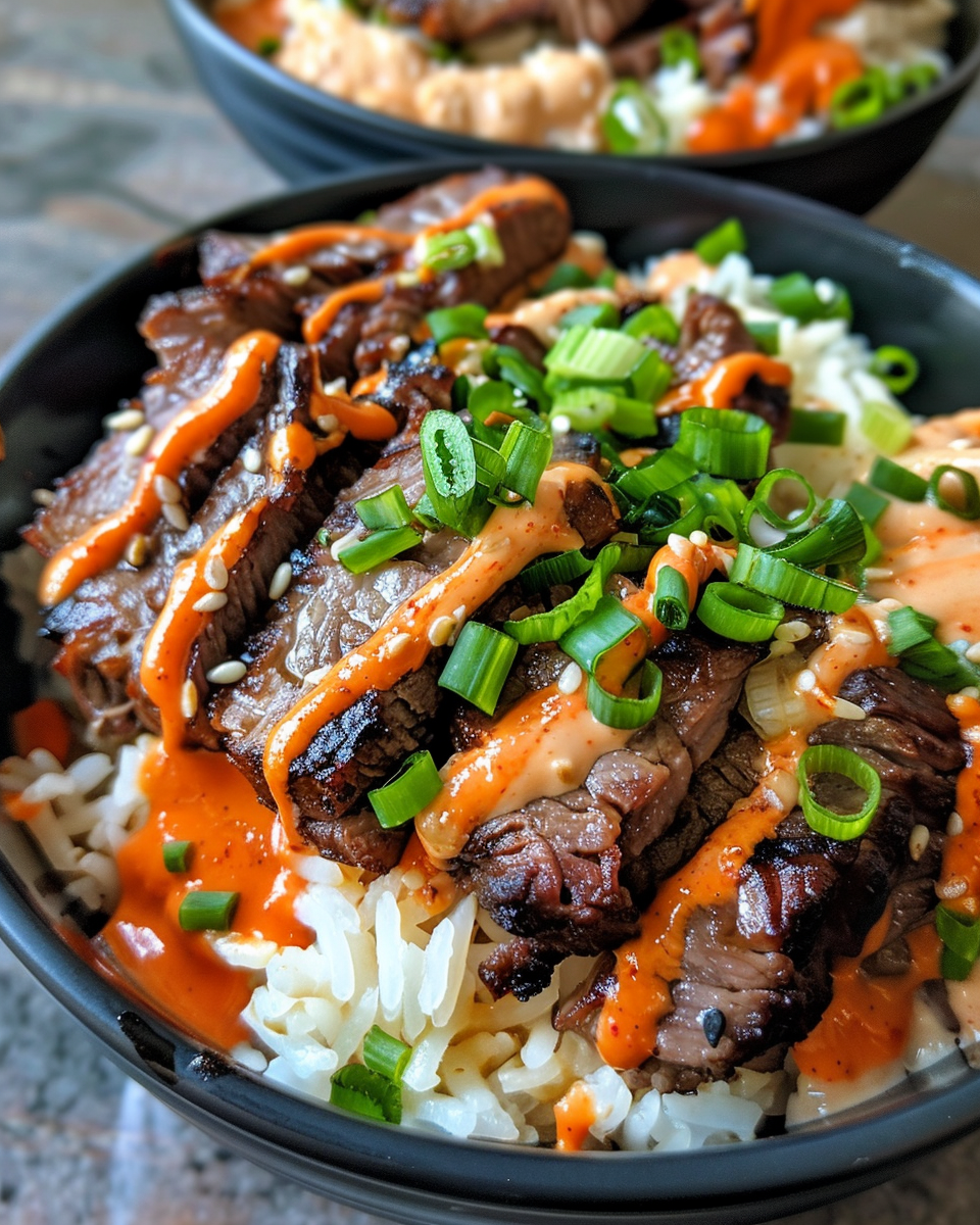 Korean BBQ steak rice bowls with spicy cream sauce in bowl with steam