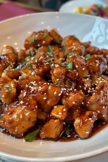 Pineapple Bourbon Chicken taken with iphone 15 pro max --iw 2 --ar 4:5 --v 6.0 --raw