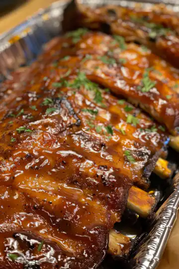 Tender Oven Baked Ribs taken with iphone 15 pro max --iw 2 --ar 4:5 --v 6.0 --raw