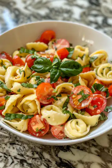 Tortellini Caprese Pasta Salad taken with iphone 15 pro max --iw 2 --ar 4:5 --v 6.0 --raw