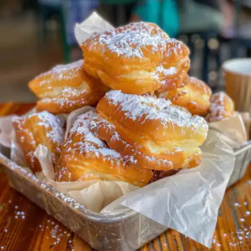Vanilla French Beignets taken with iphone 15 pro max --iw 2 --ar 4:5 --v 6.0 --raw